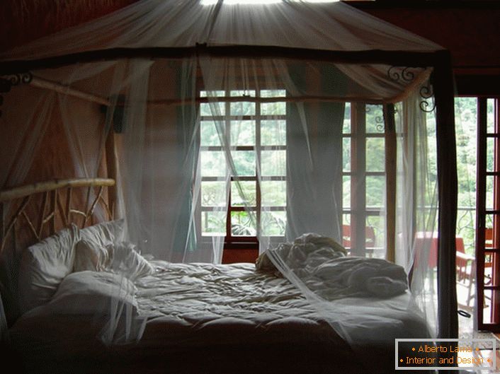 Dosel transparente y delgado en el dormitorio de una casa de campo en el sur de Italia.