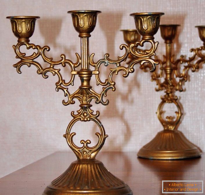 El clásico candelabro de cobre para tres velas no es solo un asistente en caso de un mal funcionamiento de la red eléctrica, sino que también es un detalle elegante de cualquier interior.