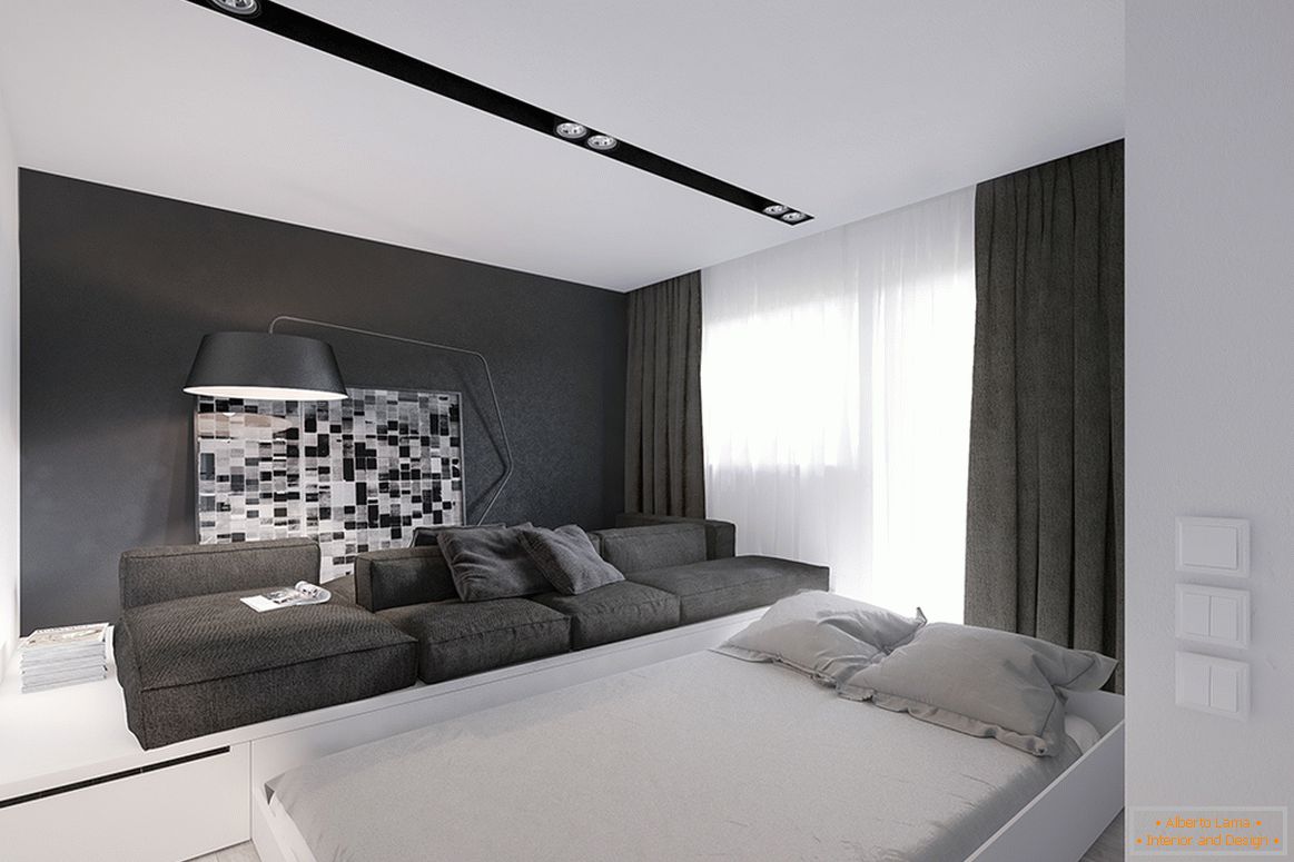 Una cama extraíble en la sala de estar de un pequeño apartamento