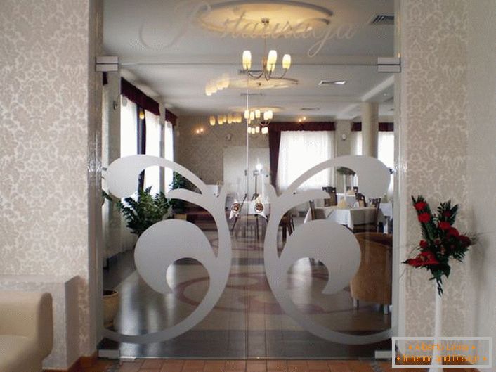 Las puertas de vidrio en el estilo Art Nouveau están decoradas con un patrón plateado simétrico adornado. Un detalle original para un interior moderno. 