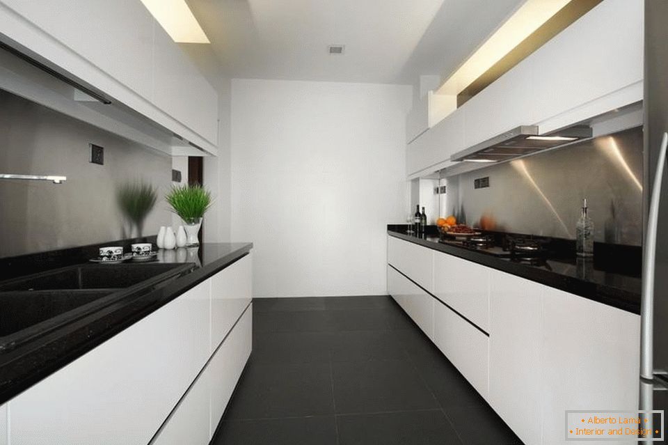 Una cocina blanca estrecha y larga con un piso negro