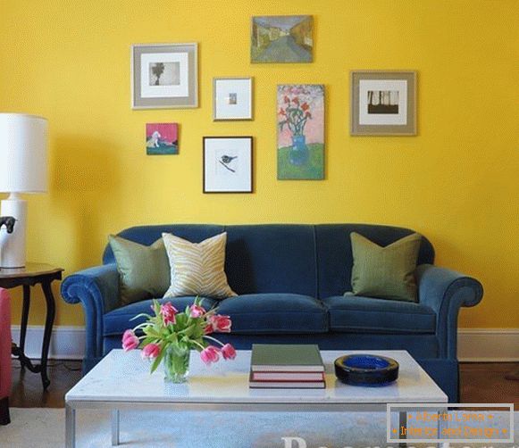 Sofá azul sobre un fondo amarillo de la pared