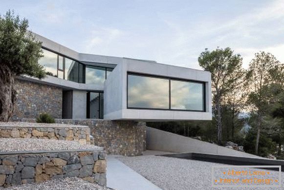 Construyendo una casa en el estilo de alta tecnología y concreto y piedra