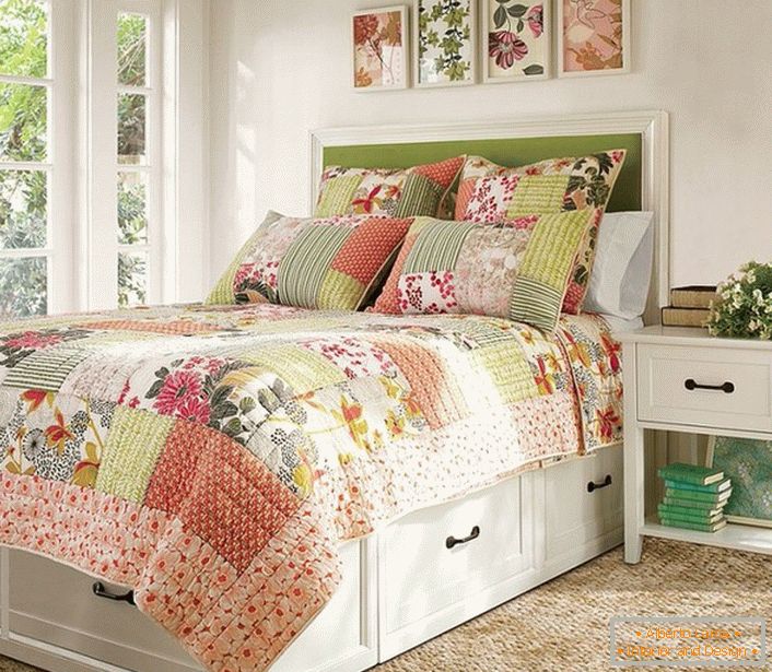 De acuerdo con el estilo rural, se eligen elementos decorativos para el dormitorio. Almohadas y cuadros con estilo