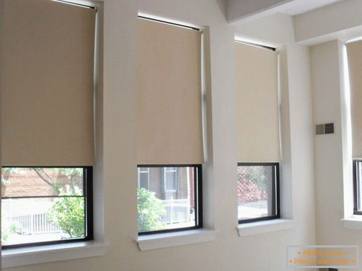 Las persianas enrollables opcionales de tela de tres capas blekaut tonos beige claros crean un ambiente acogedor en la habitación y protegen de la luz brillante de las luces de la noche.